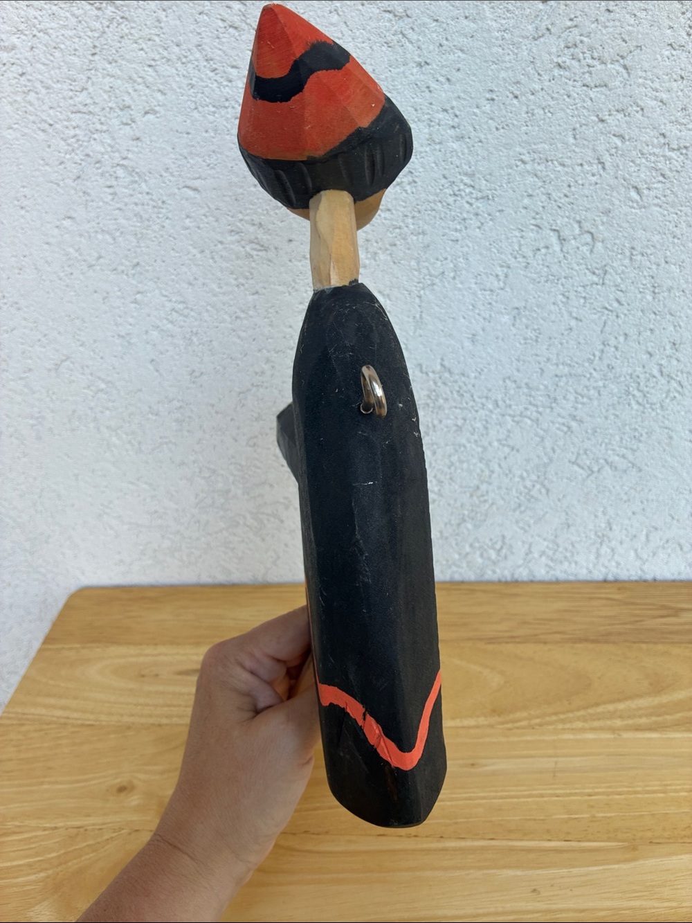 Strange hand carved folk art character with bland and orange clothes and a hook - Picture 10 of 13